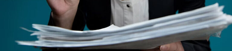 A young woman puts glasses on her nose and looks at documents with angry surprise_ Directo